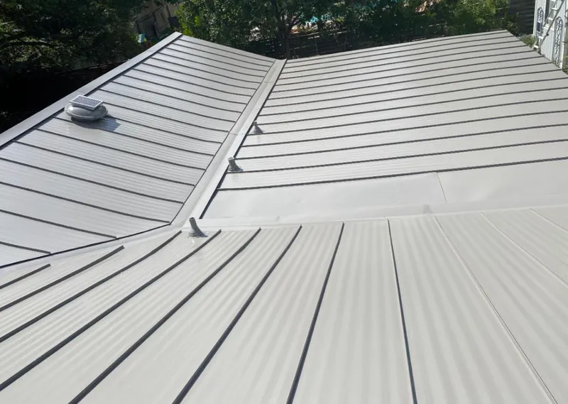 Solar attic fan installed on a metal roof for Roof Ventilation in Oak Point